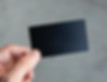fingers holding a business card saying The Low-Carb Club Membership